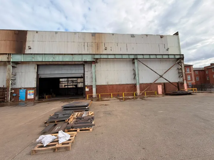 Industrial building facade before commercial pressure washing