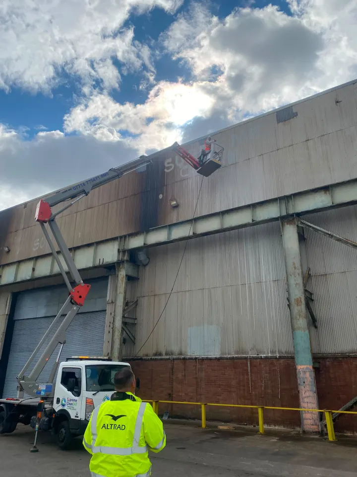 High-access pressure washing of industrial cladding