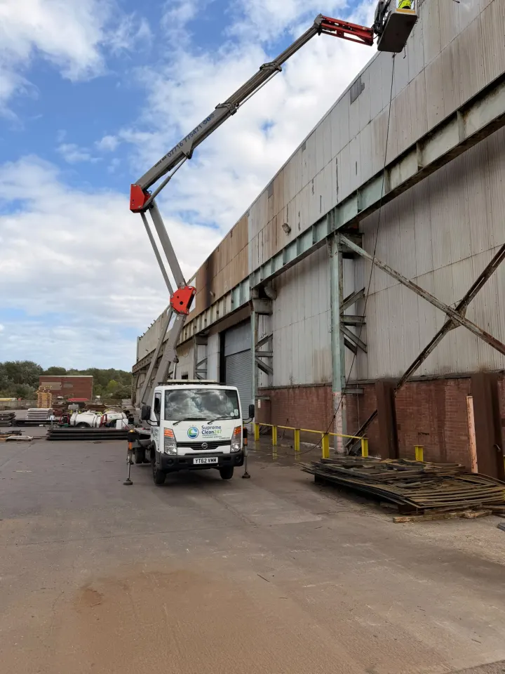 Supreme Clean branded cherry picker carrying out high-level cleaning