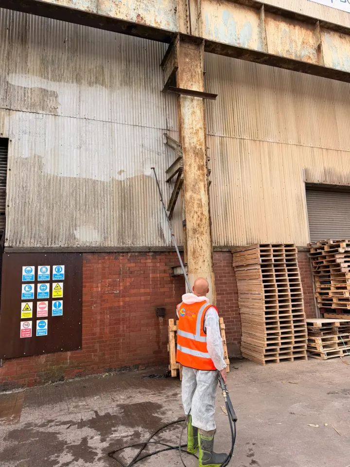 Visible cleaning progress across industrial wall cladding