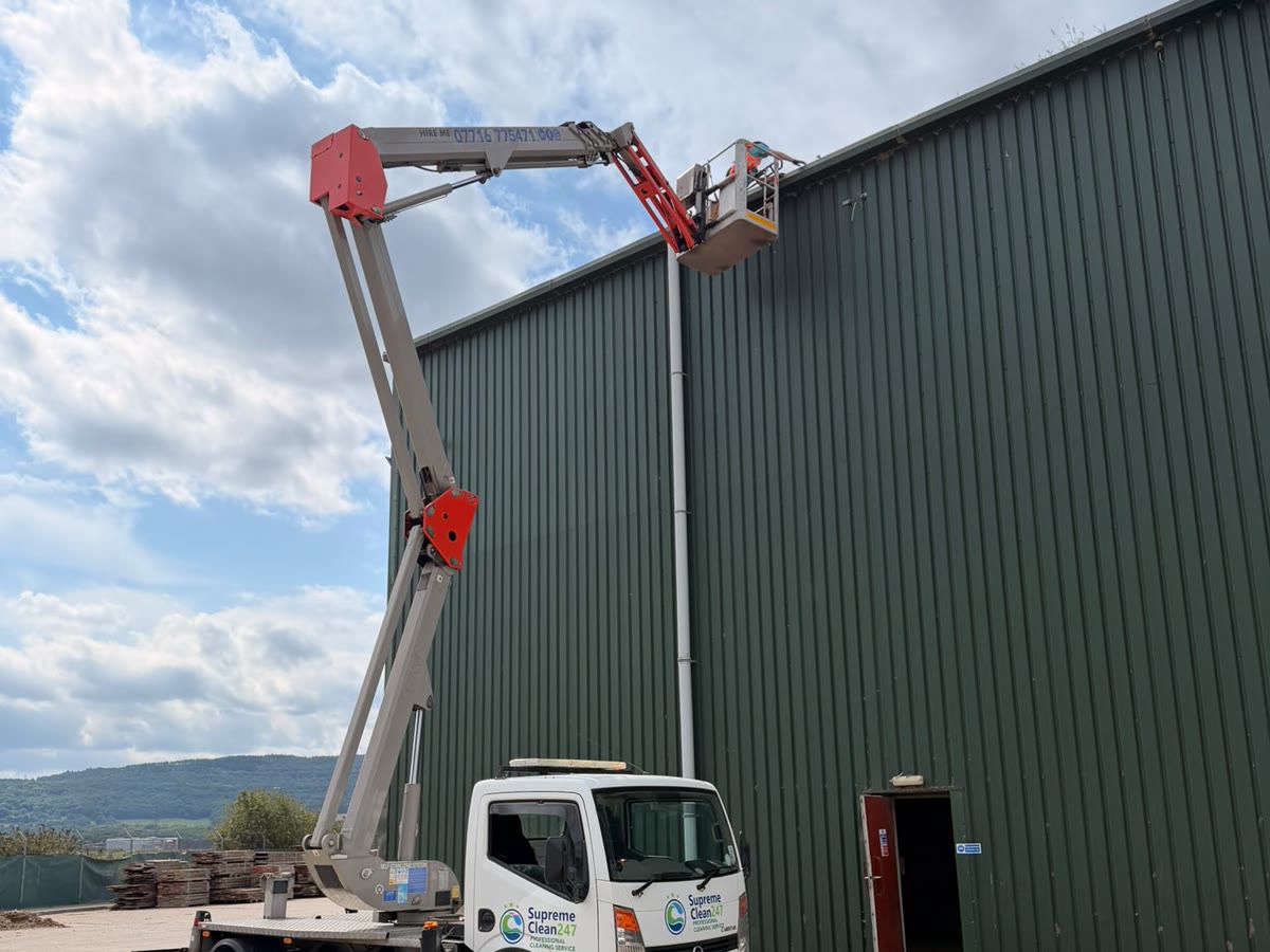 Supreme Clean cherry picker providing high-level access to a commercial industrial roof