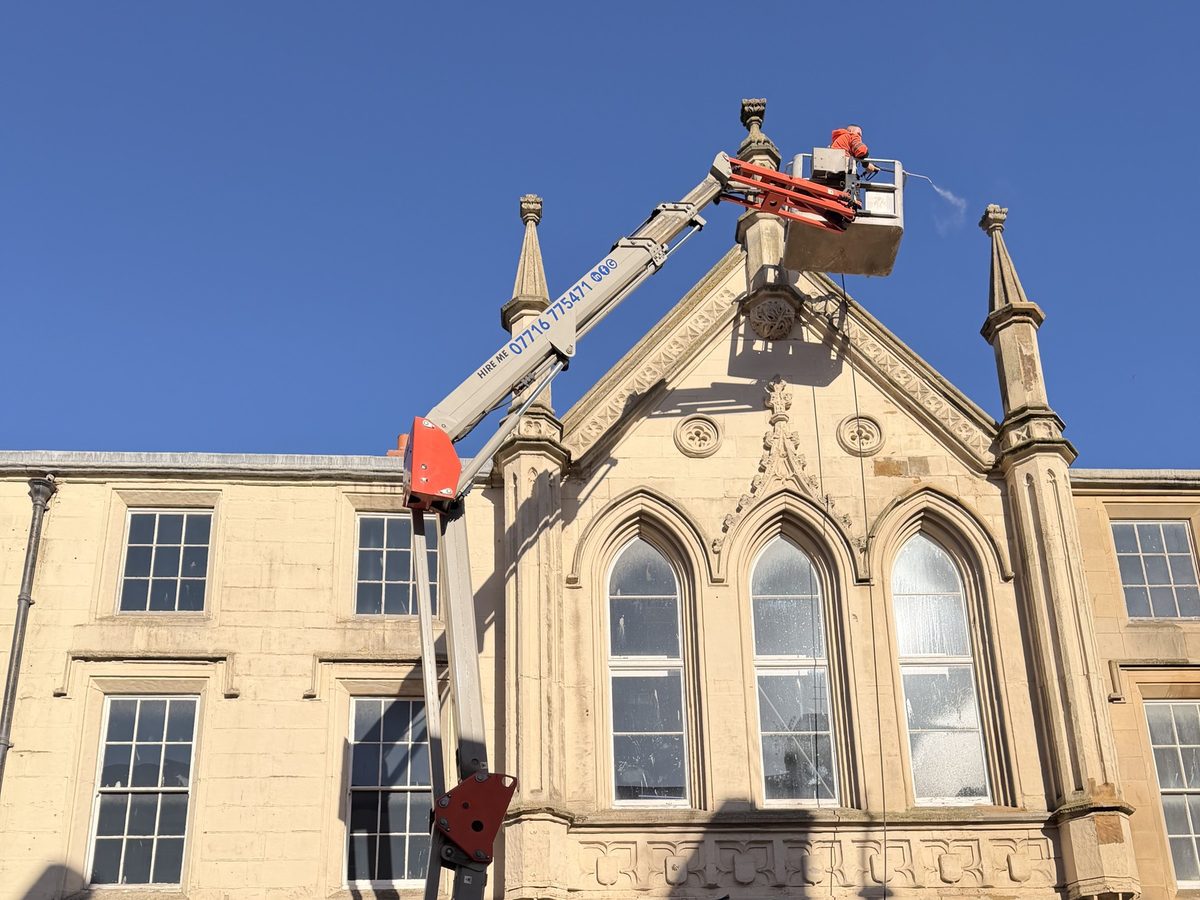 Supreme Clean cherry picker DOFF steam cleaning a heritage stone facade