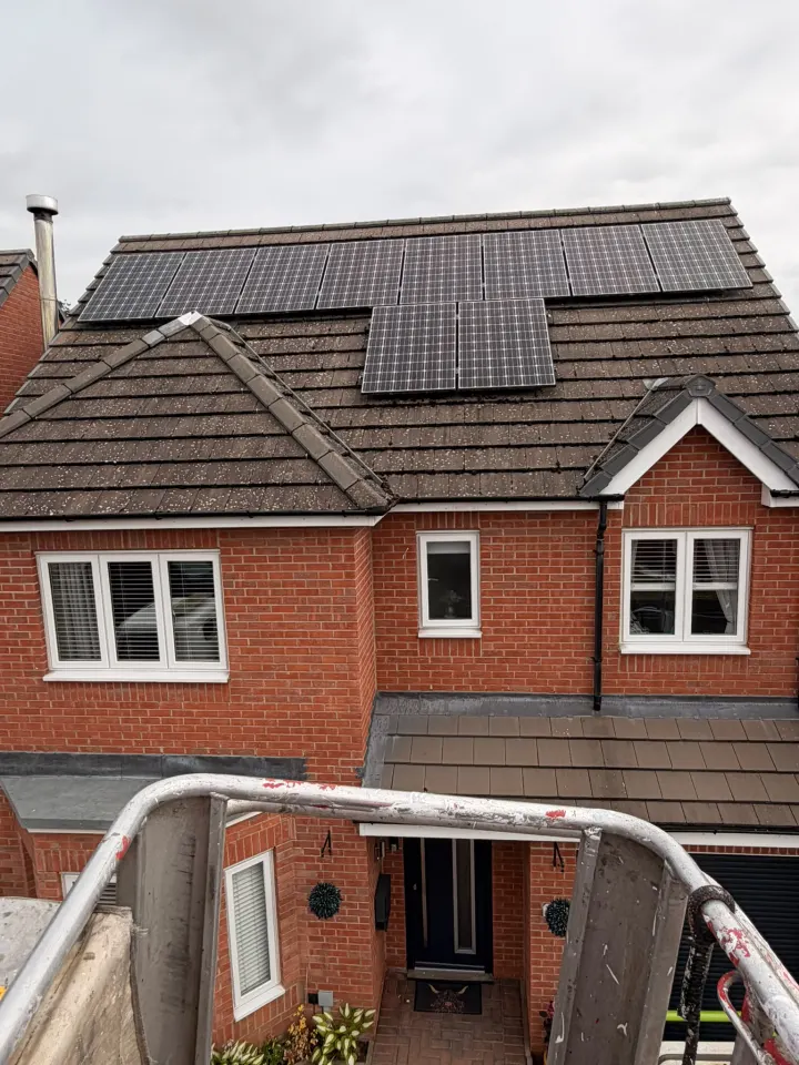 Residential tiled roof and solar panels viewed from the access platform