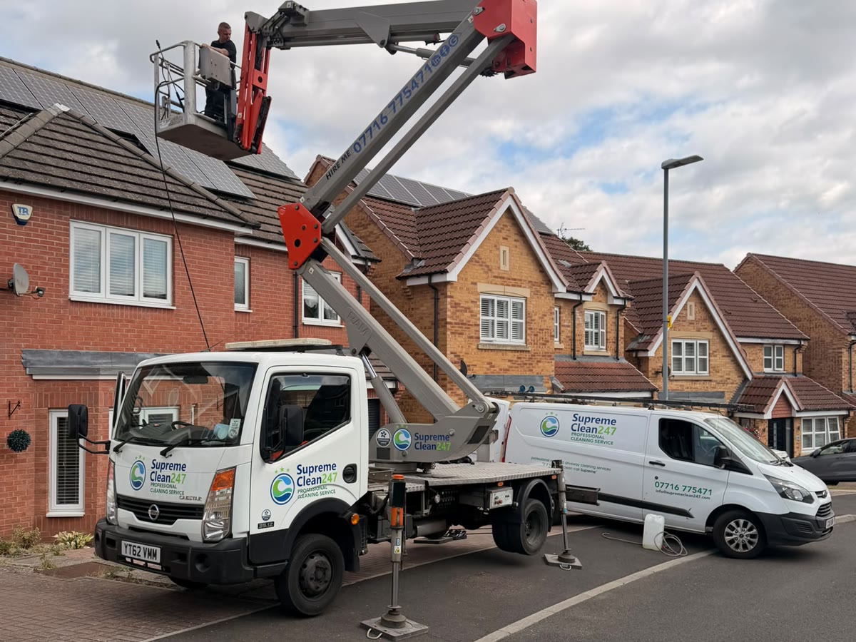 Supreme Clean cherry picker and cleaning van working on a residential roof