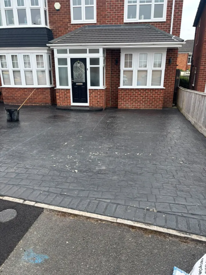 Dark stamped concrete residential driveway