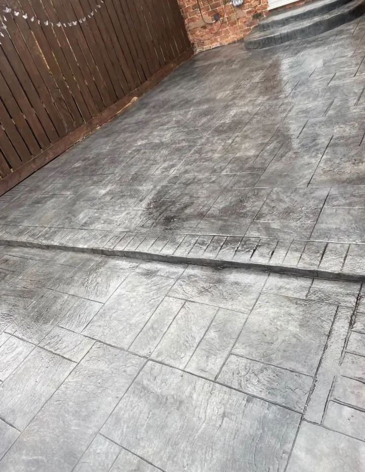 Clean grey stamped concrete driveway