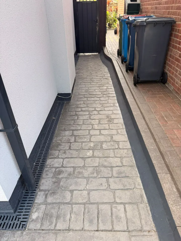 Cleaned paved access path beside a home